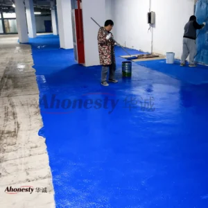 Large-scale parking garage floor coated with EM45 waterborne polymer anti-slip system during construction, designed for high-traffic and safety-focused environments.