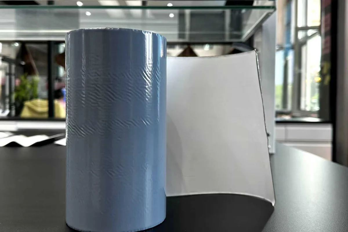 Roll and sheet of white radiative cooling film